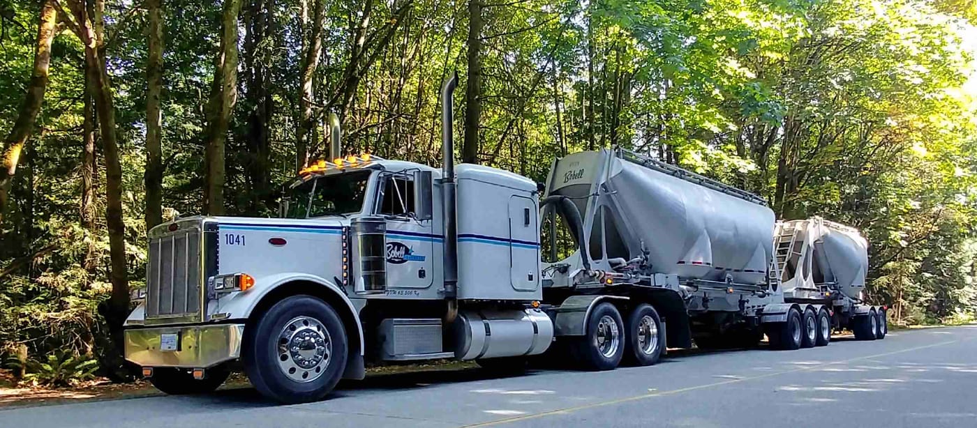 Bobell Express truck with bulk tanker trailers on a forest road